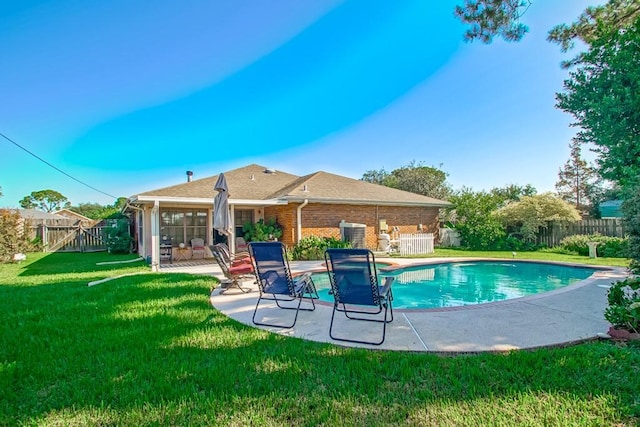 view of pool with a yard, a fenced backyard, a fenced in pool, and a patio