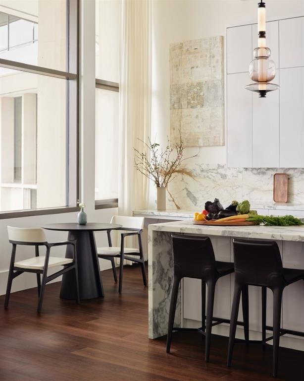 bar featuring tasteful backsplash, dark wood-type flooring, and white cabinets