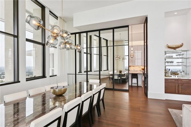 dining space featuring plenty of natural light, dark hardwood / wood-style floors, and a chandelier