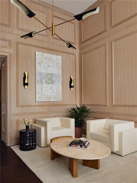 sitting room featuring wooden walls and light hardwood / wood-style floors