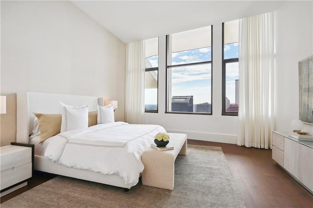 bedroom featuring vaulted ceiling and dark hardwood / wood-style floors