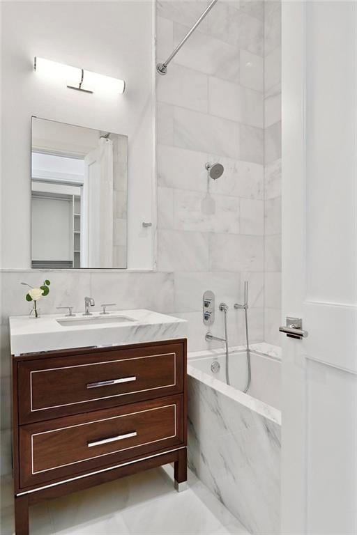 bathroom with vanity and tiled shower / bath combo