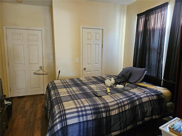 bedroom with dark wood-type flooring