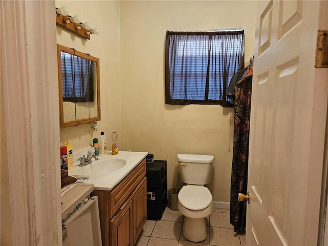 bathroom featuring tile flooring, vanity with extensive cabinet space, and toilet