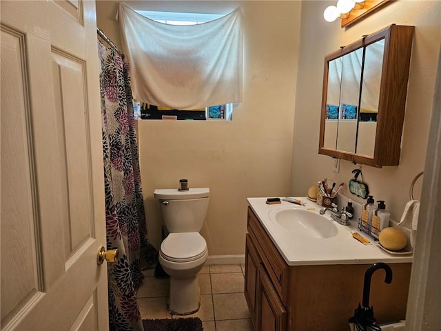 bathroom with tile floors, toilet, and large vanity