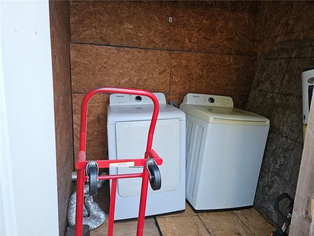 laundry room featuring washing machine and clothes dryer and light tile floors