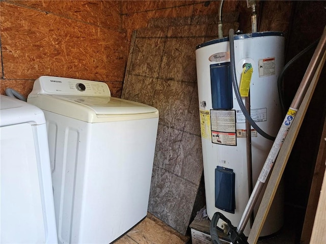 laundry area with tile flooring, water heater, and washer and clothes dryer