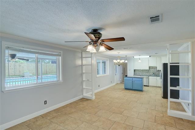 interior space featuring crown molding, a textured ceiling, and ceiling fan with notable chandelier