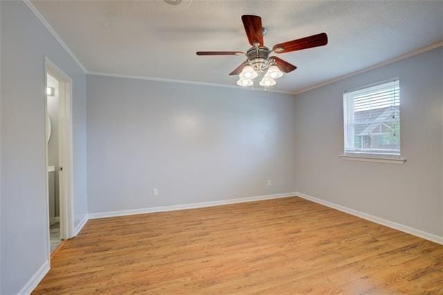 spare room featuring ceiling fan, crown molding, and light hardwood / wood-style floors