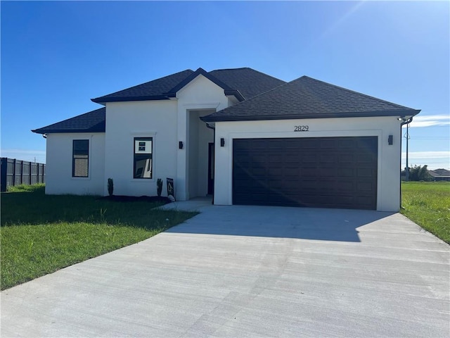 view of front of home featuring a front yard and a garage