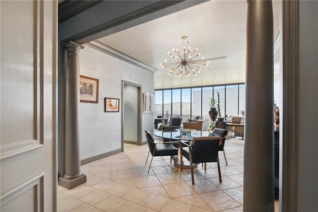 tiled dining area with decorative columns, a notable chandelier, and ornamental molding