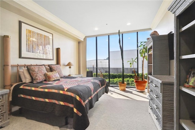 carpeted bedroom featuring expansive windows and crown molding