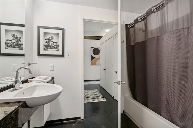 bathroom with concrete floors, shower / tub combo with curtain, and vanity with extensive cabinet space