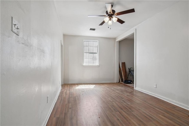 unfurnished room with dark hardwood / wood-style floors and ceiling fan