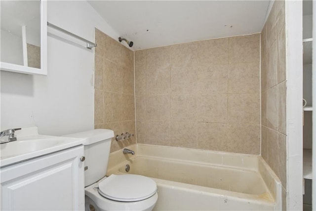 full bathroom featuring tiled shower / bath combo, toilet, and vanity