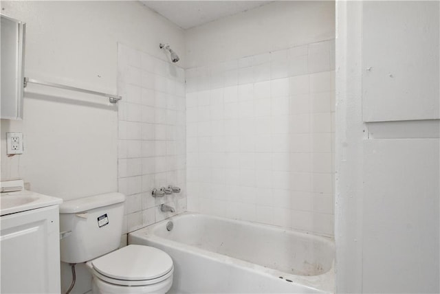 full bathroom with tiled shower / bath, toilet, and vanity