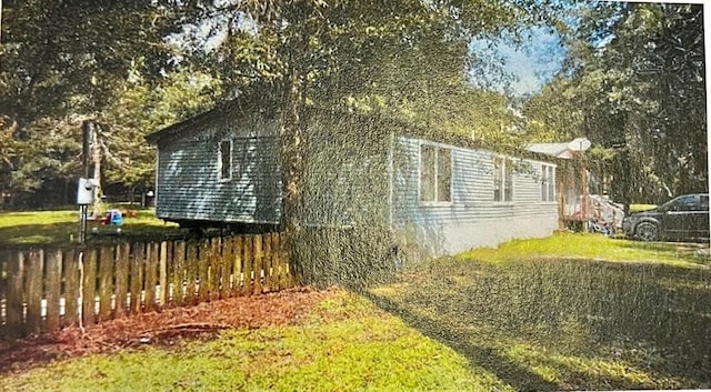 view of side of home featuring a lawn