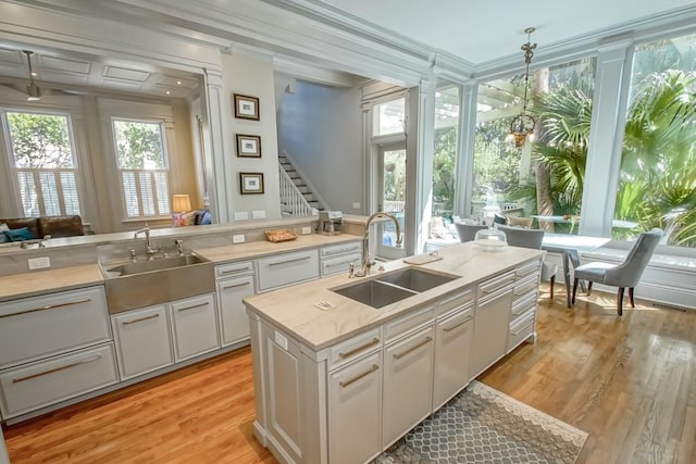 kitchen featuring light hardwood / wood-style floors, sink, and white cabinets