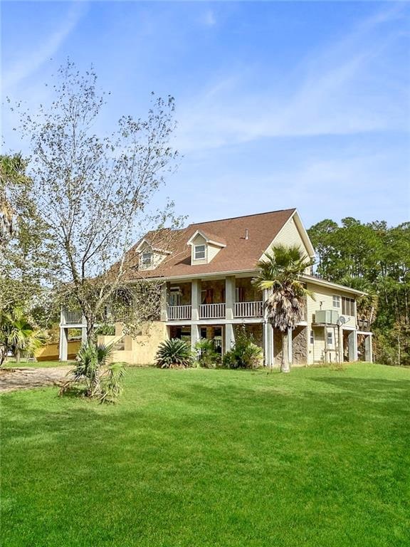 rear view of property with a yard