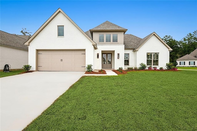 view of front of home featuring a garage, a front yard, and french doors