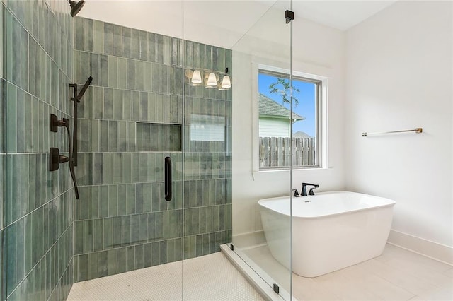 bathroom featuring tile patterned flooring and shower with separate bathtub