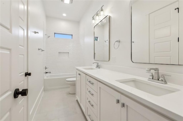 full bathroom featuring toilet, tiled shower / bath, tile patterned flooring, and vanity