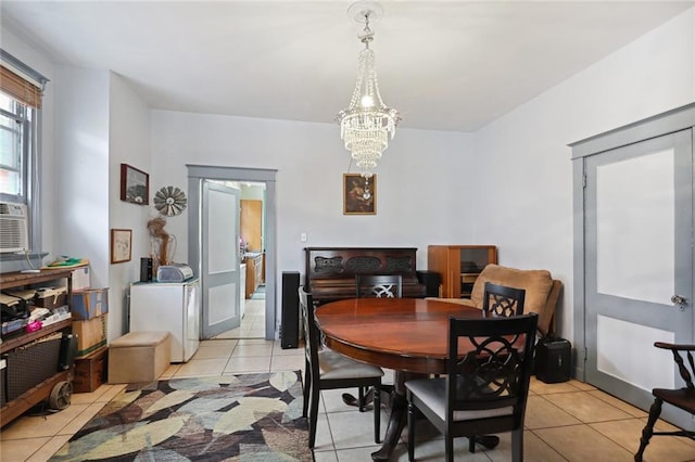 tiled dining room featuring an inviting chandelier