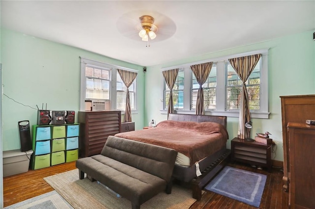 bedroom featuring dark hardwood / wood-style floors and ceiling fan