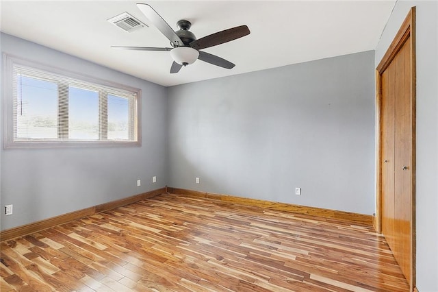 empty room featuring ceiling fan and light hardwood / wood-style floors