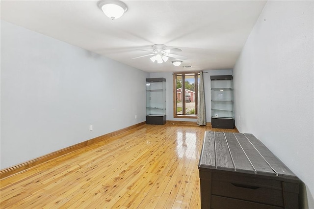 unfurnished room with ceiling fan and light hardwood / wood-style flooring