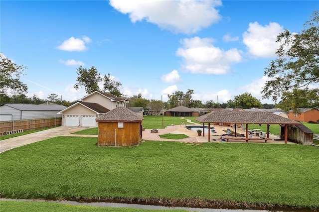 view of yard with a swimming pool, a gazebo, an outdoor structure, and a patio