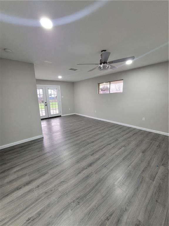 spare room featuring ceiling fan, dark wood-type flooring, and french doors