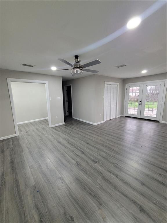 spare room with dark wood-type flooring, ceiling fan, and french doors