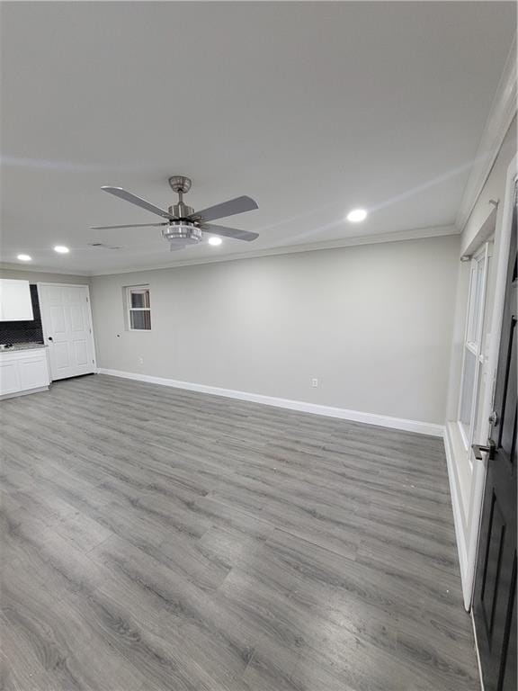 interior space featuring ornamental molding, ceiling fan, and light hardwood / wood-style flooring