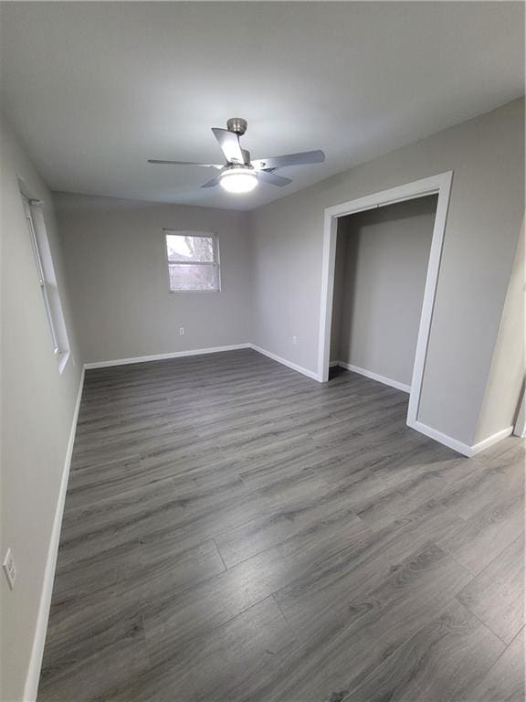 unfurnished room with dark hardwood / wood-style floors and ceiling fan