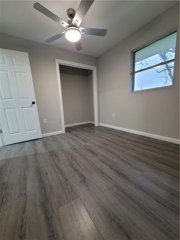 unfurnished bedroom featuring ceiling fan, a closet, and dark hardwood / wood-style floors