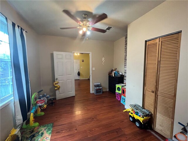 game room featuring ceiling fan and dark wood-type flooring