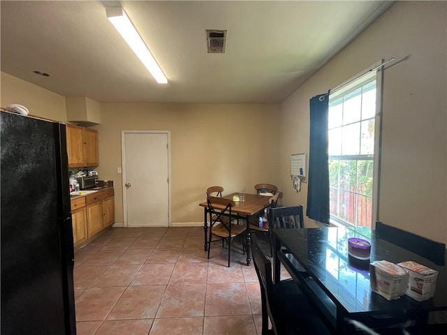 dining space featuring light tile flooring