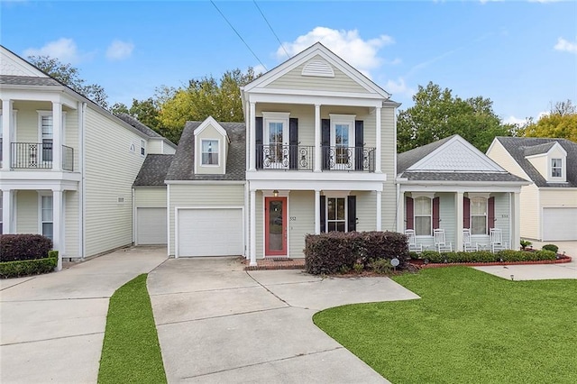 neoclassical home featuring a front yard, a balcony, and covered porch