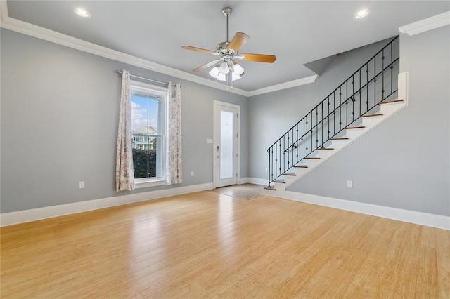 entrance foyer featuring ornamental molding, light hardwood / wood-style floors, and ceiling fan