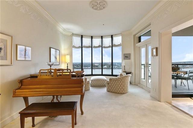 miscellaneous room with light carpet, crown molding, a water view, and french doors