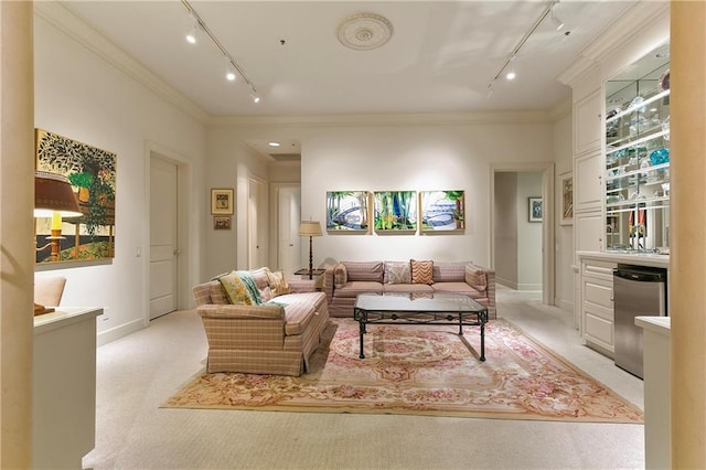 carpeted living room featuring rail lighting and crown molding