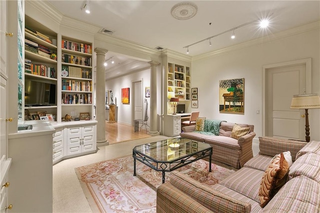 sitting room with ornamental molding, decorative columns, and built in features