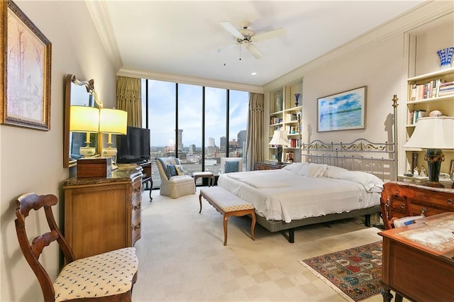 carpeted bedroom featuring expansive windows, ornamental molding, and ceiling fan