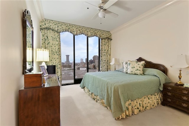 carpeted bedroom with access to outside, ornamental molding, and ceiling fan