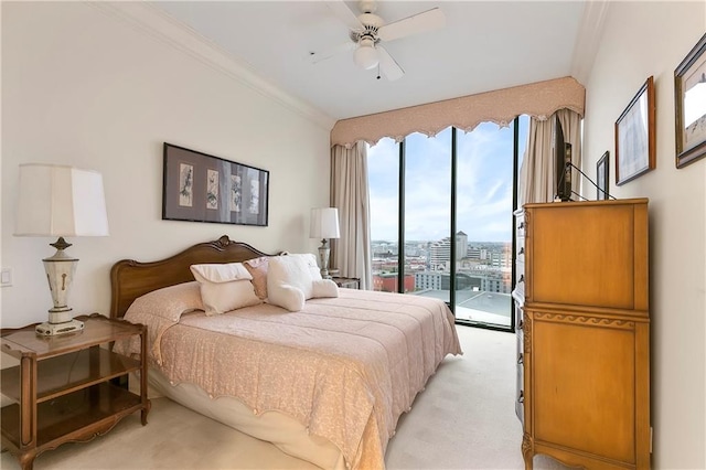 bedroom featuring ornamental molding, access to exterior, ceiling fan, and light colored carpet