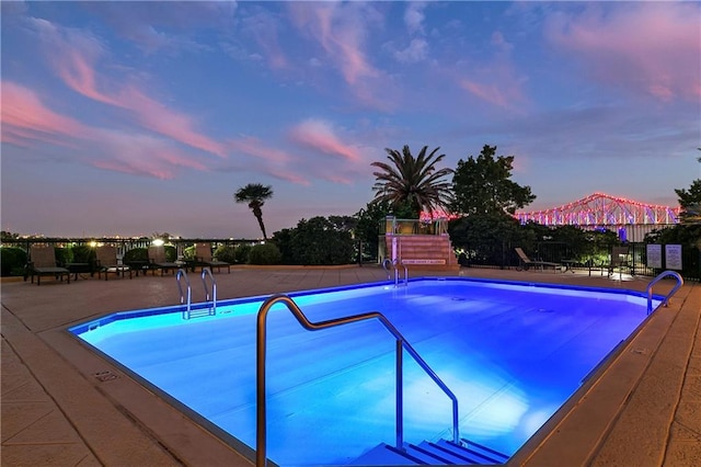 pool at dusk with a patio