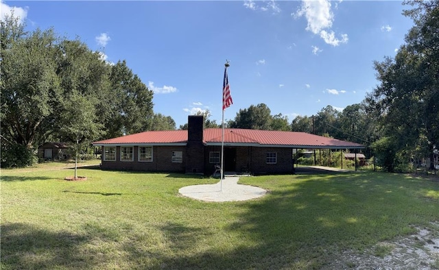 exterior space with a carport and a lawn