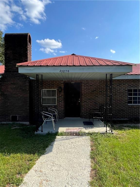 rear view of property with a yard