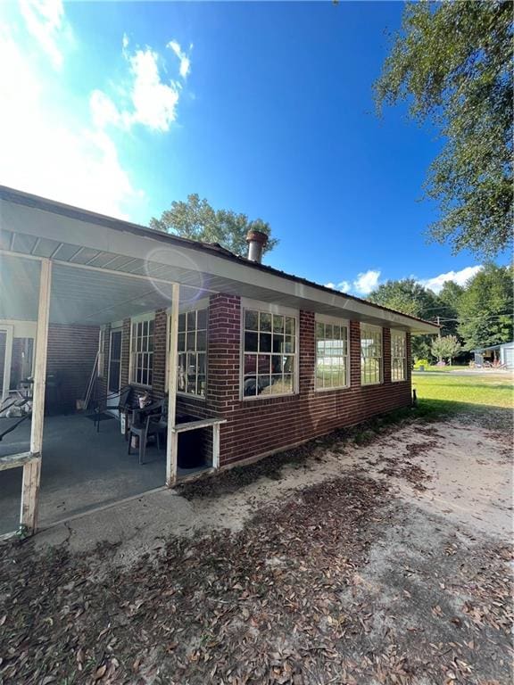 view of side of property featuring a patio area